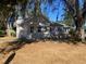 House exterior showcasing the back and side yards with mature trees at 373 E Waldo St, Groveland, FL 34736