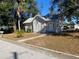 House exterior with street view, showcasing landscaping and a paved pathway at 373 E Waldo St, Groveland, FL 34736