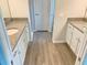 Double vanity bathroom with granite countertops and white cabinets at 6435 Sw 204 Ave, Dunnellon, FL 34431