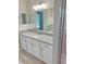 Bathroom boasts a granite countertop vanity and a large mirror at 6435 Sw 204 Ave, Dunnellon, FL 34431