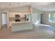 Open concept kitchen with an island, stainless steel appliances, and light-colored cabinetry at 6435 Sw 204 Ave, Dunnellon, FL 34431