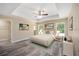 Spacious main bedroom with a ceiling fan, large windows, and ample closet space at 6435 Sw 204 Ave, Dunnellon, FL 34431