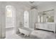 Bright bathroom features tiled floors, a soaking tub, and and vanities with lighting at 8570 Nw 31St Lane Rd, Ocala, FL 34482