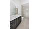 Stylish bathroom featuring a sleek vanity with a white countertop, a framed mirror, and a glass-enclosed shower at 8570 Nw 31St Lane Rd, Ocala, FL 34482