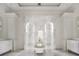 Bright bathroom offers tiled floors, a soaking tub, and and vanities with lighting at 8570 Nw 31St Lane Rd, Ocala, FL 34482
