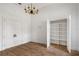 Bright bedroom features hardwood floors, closet with shelving, and decorative lighting at 8570 Nw 31St Lane Rd, Ocala, FL 34482
