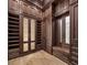 Spacious walk-in closet with wood cabinetry, shelving, drawers, and mirror at 8570 Nw 31St Lane Rd, Ocala, FL 34482