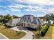 Expansive home with circular driveway, a large manicured front lawn, and mature landscaping at 8570 Nw 31St Lane Rd, Ocala, FL 34482
