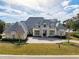 Grand home features a manicured lawn, elegant entrance, and circular brick driveway at 8570 Nw 31St Lane Rd, Ocala, FL 34482