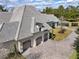 A three-car garage and brick driveway surrounded by lush landscaping at 8570 Nw 31St Lane Rd, Ocala, FL 34482