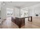 Bright gourmet kitchen featuring a large island with farmhouse sink, custom cabinets, and wood flooring at 8570 Nw 31St Lane Rd, Ocala, FL 34482