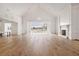 Bright living room features hardwood floors, chandelier, fireplace, and view of pool area at 8570 Nw 31St Lane Rd, Ocala, FL 34482