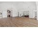 Living room with wood floors, chandeliers, kitchen access, and front entryway access at 8570 Nw 31St Lane Rd, Ocala, FL 34482