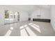 A large open space with a view of the outdoor pool and patio, adjacent to the kitchen area at 8570 Nw 31St Lane Rd, Ocala, FL 34482