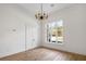 Bright, empty room with hardwood flooring, natural light from large windows, and chandelier at 8570 Nw 31St Lane Rd, Ocala, FL 34482