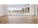 Living room featuring hardwood floors and large windows with a view of the pool at 8570 Nw 31St Lane Rd, Ocala, FL 34482