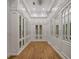 Spacious walk-in closet featuring custom shelving, ample storage and hardwood floors at 8570 Nw 31St Lane Rd, Ocala, FL 34482