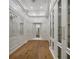 Bright walk-in closet featuring custom shelving, ample storage and hardwood floors at 8570 Nw 31St Lane Rd, Ocala, FL 34482
