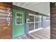 Stylish front entrance showcasing a green door, modern house number, and a unique tiled porch area at 2707 Illinois St, Orlando, FL 32803