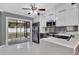 Modern kitchen featuring stainless steel appliances, white cabinetry, and an adjacent screened patio at 2707 Illinois St, Orlando, FL 32803