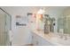 Sleek bathroom with double sinks, modern vanity, glass-enclosed shower and minimalist decor at 2026 Babbling Brook Blvd, Auburndale, FL 33823