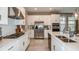 Well-equipped kitchen with stainless steel appliances, an island sink, and modern lighting at 2136 Babbling Brook Blvd, Auburndale, FL 33823