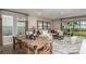 Open-concept living and dining area with neutral tones and large windows, perfect for entertaining at 2136 Babbling Brook Blvd, Auburndale, FL 33823