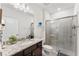 Clean bathroom featuring granite countertops, a glass-enclosed shower, and modern fixtures in a neutral color palette at 921 Paradise Dr, Davenport, FL 33897