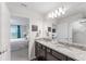 Bathroom featuring double sink vanity with granite countertops, and access to the bedroom at 921 Paradise Dr, Davenport, FL 33897