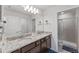 Bright bathroom showcasing a double sink vanity with granite counters and a glass shower at 921 Paradise Dr, Davenport, FL 33897