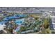 An aerial view shows the community water park with large pool, slides, lazy river and landscaping at 921 Paradise Dr, Davenport, FL 33897