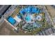 An aerial view shows the community water park with large pool, lazy river, and basketball court at 921 Paradise Dr, Davenport, FL 33897