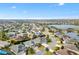 Aerial view of a charming home with a screened-in pool, a lake nearby, and many other homes in the neighborhood at 3303 Ridgewood Path, The Villages, FL 32163