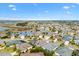 Aerial view of a home with a screened-in pool, a pond nearby, and many other homes in the neighborhood at 3303 Ridgewood Path, The Villages, FL 32163