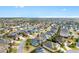 Aerial view of a charming home with a screened-in pool in a well-maintained residential neighborhood at 3303 Ridgewood Path, The Villages, FL 32163