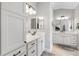 Bright bathroom features double vanities with quartz countertops, framed mirrors, and modern fixtures at 3303 Ridgewood Path, The Villages, FL 32163