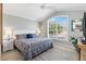 Relaxing bedroom with a large window, providing natural light, complemented by a ceiling fan at 3303 Ridgewood Path, The Villages, FL 32163