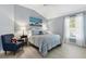 Cozy bedroom featuring a vaulted ceiling, picture window, and comfortable sitting area at 3303 Ridgewood Path, The Villages, FL 32163