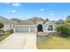 Charming single-story home with a three-car garage and well-maintained landscaping at 3303 Ridgewood Path, The Villages, FL 32163