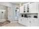 This kitchen features white cabinetry, stainless steel hardware, and a coffee bar area near the entry at 3303 Ridgewood Path, The Villages, FL 32163