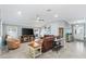 Bright and airy living room with a large sectional sofa, perfect for relaxing and unwinding at 3303 Ridgewood Path, The Villages, FL 32163