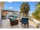 Cozy outdoor patio featuring comfortable seating, a fire pit, and a screened-in pool area for relaxation and entertainment at 3303 Ridgewood Path, The Villages, FL 32163