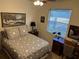 Bedroom with a patterned bedspread, a window, and a desk at 4622 Warrington Dr, Orlando, FL 32826