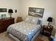 Bedroom featuring a patterned bedspread, a window, and a wooden dresser at 4622 Warrington Dr, Orlando, FL 32826