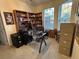 Office with a glass desk, wood bookshelves, and lots of filing cabinets at 4622 Warrington Dr, Orlando, FL 32826