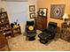 Sitting area featuring two black leather chairs, wood furniture, and carpeted floors at 4622 Warrington Dr, Orlando, FL 32826