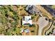 An aerial view of the property showcasing its backyard, solar panels, and proximity to the lake at 603 Pinehurst Ct, Kissimmee, FL 34758
