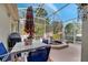 Enclosed patio showcasing patio furniture, a grill, and a water feature surrounded by tropical decor at 603 Pinehurst Ct, Kissimmee, FL 34758