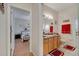 A bathroom with single vanity, medicine cabinet, and direct access to a bedroom at 603 Pinehurst Ct, Kissimmee, FL 34758