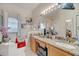 A bathroom with double sinks, granite countertops, a soaking tub, and decor at 603 Pinehurst Ct, Kissimmee, FL 34758